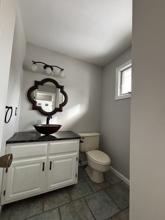 2205 Boston Road, Unit M120 Wilbraham, MA 01095 - Photo 6 of 19 a bathroom with a toilet a sink and a mirror