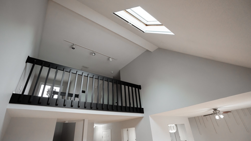 2205 Boston Road, Unit M120 Wilbraham, MA 01095 - Photo 10 of 19 a view of staircase with lots of frames on wall and a window