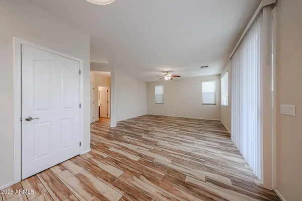 a view of a room with wooden floor and window