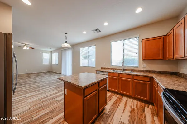 a kitchen with stainless steel appliances granite countertop a sink stove and refrigerator