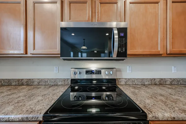 a stove top oven sitting inside of a kitchen