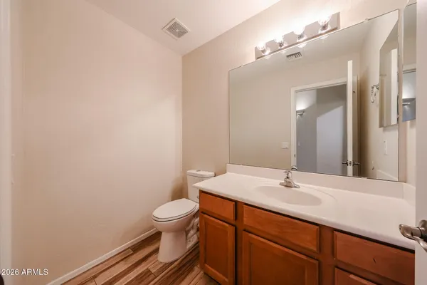 a bathroom with a sink a toilet and a mirror