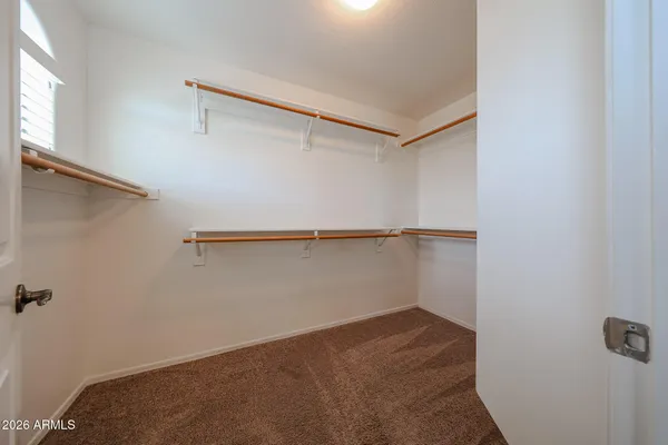 a spacious bathroom with a double vanity sink a mirror and a shower