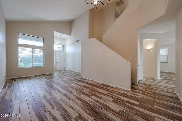 a view of a room with wooden floor and window
