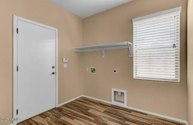 a view of a room with a wooden floor and a window