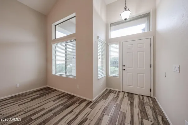 a view of a room with wooden floor and window