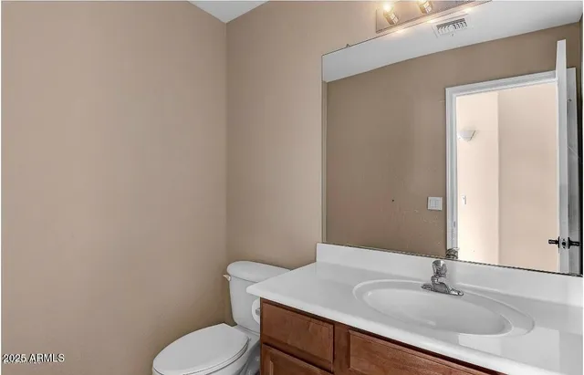 a bathroom with a sink toilet and mirror