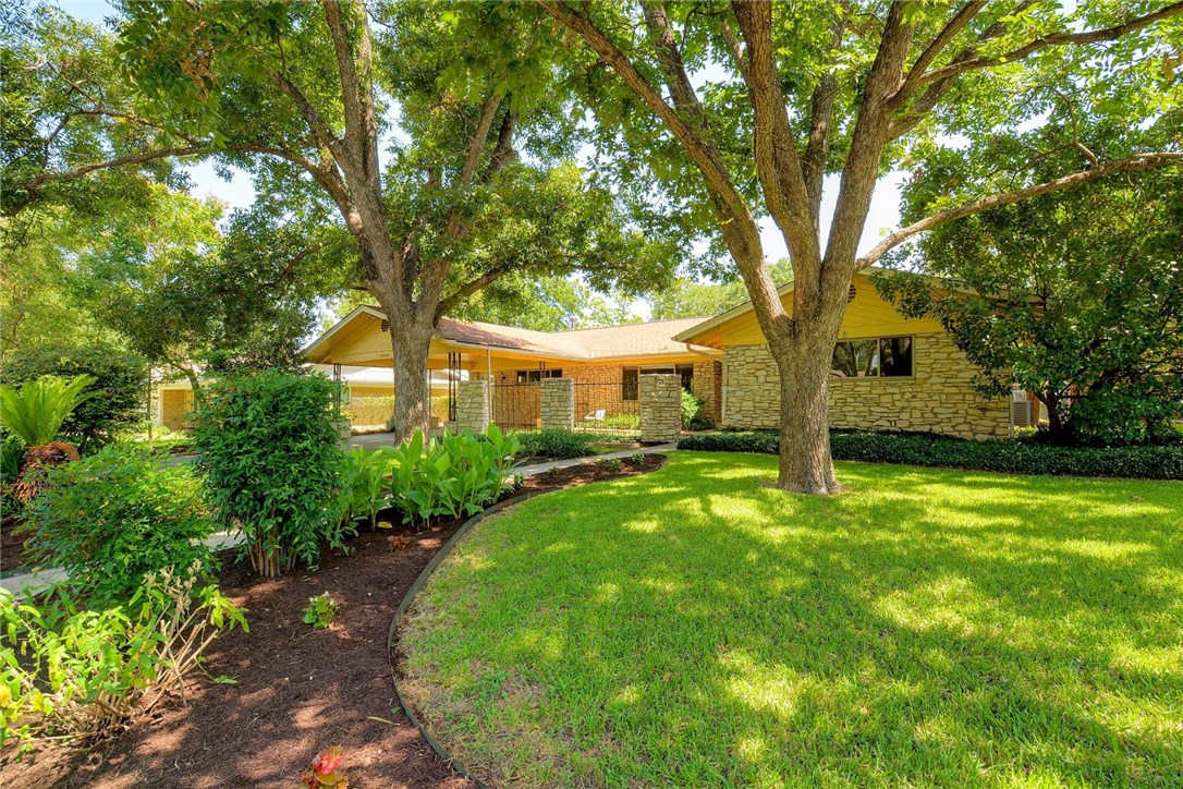 2702 Cascade Drive Austin, TX 78757 - Photo 1 of 1 a front view of a house with garden