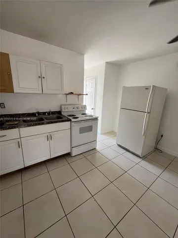 a kitchen with cabinets and sink
