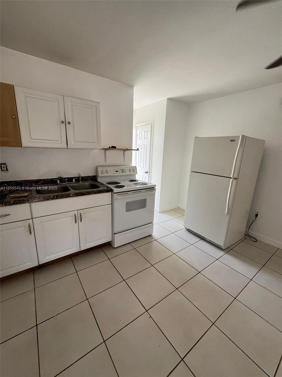 1915 Fletcher Street, Unit W4 Hollywood, FL 33020 - Photo 3 of 8 a kitchen with cabinets and sink