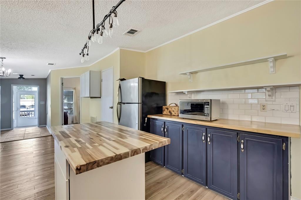 2400 Lemur Drive Holiday, FL 34690 - Photo 13 of 39 a kitchen with kitchen island a refrigerator stove and sink