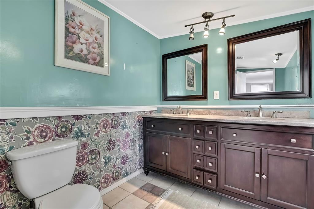 2400 Lemur Drive Holiday, FL 34690 - Photo 23 of 39 a bathroom with a granite countertop toilet sink and mirror