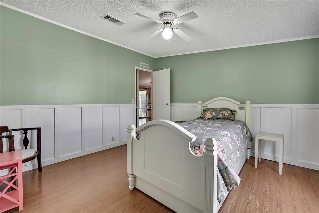 2400 Lemur Drive Holiday, FL 34690 - Photo 27 of 39 a bedroom with a bed and a chandelier