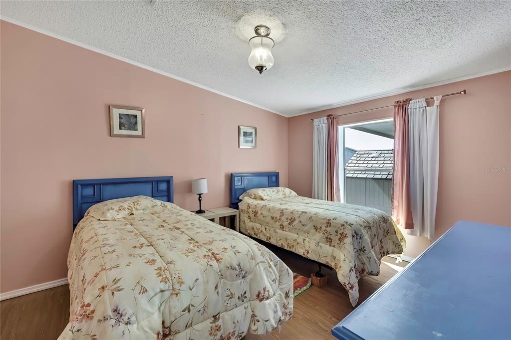 2400 Lemur Drive Holiday, FL 34690 - Photo 30 of 39 a bedroom with two beds and a chandelier