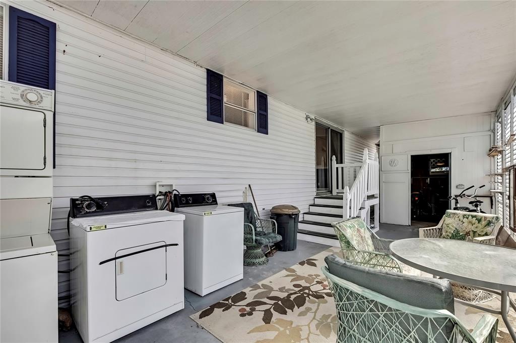 2400 Lemur Drive Holiday, FL 34690 - Photo 36 of 39 a kitchen with granite countertop a stove a sink a dining table and chairs