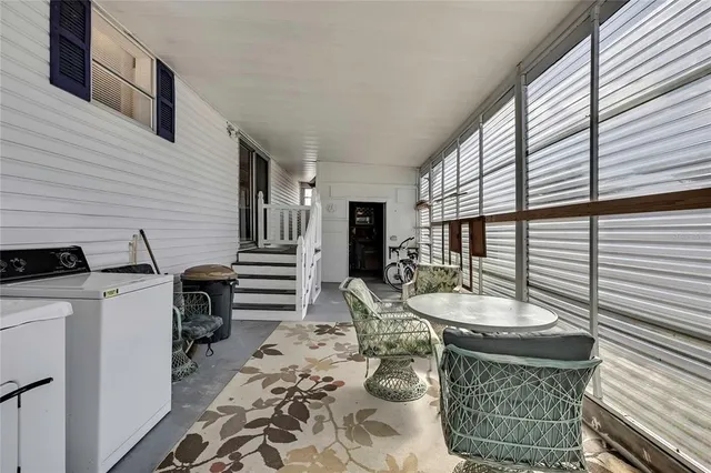 a view of a patio with table and chairs and couches