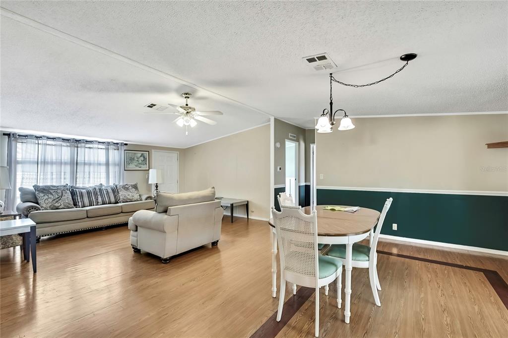 2400 Lemur Drive Holiday, FL 34690 - Photo 4 of 39 a living room with furniture and a chandelier