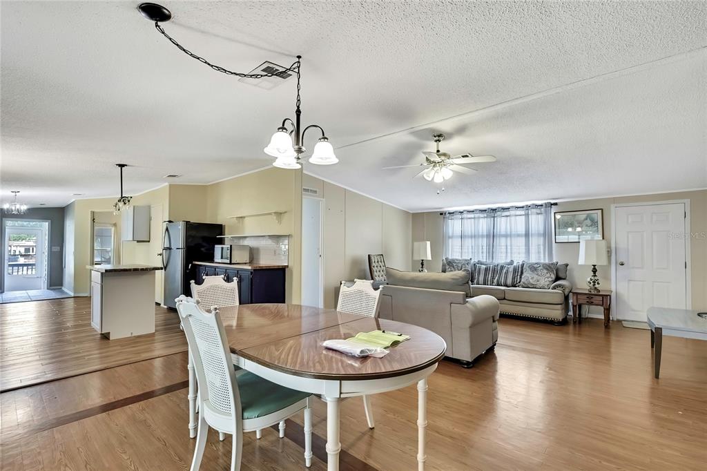 2400 Lemur Drive Holiday, FL 34690 - Photo 5 of 39 a view of a dining room with furniture and wooden floor