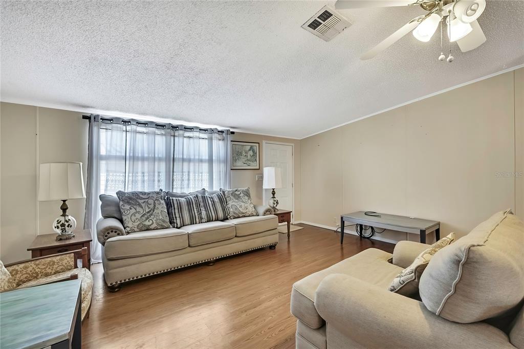 2400 Lemur Drive Holiday, FL 34690 - Photo 8 of 39 a living room with furniture and a large window