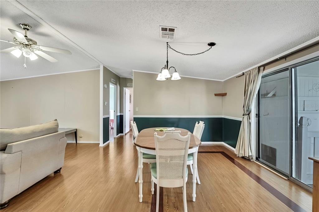 2400 Lemur Drive Holiday, FL 34690 - Photo 10 of 39 a view of a dining room with furniture and wooden floor