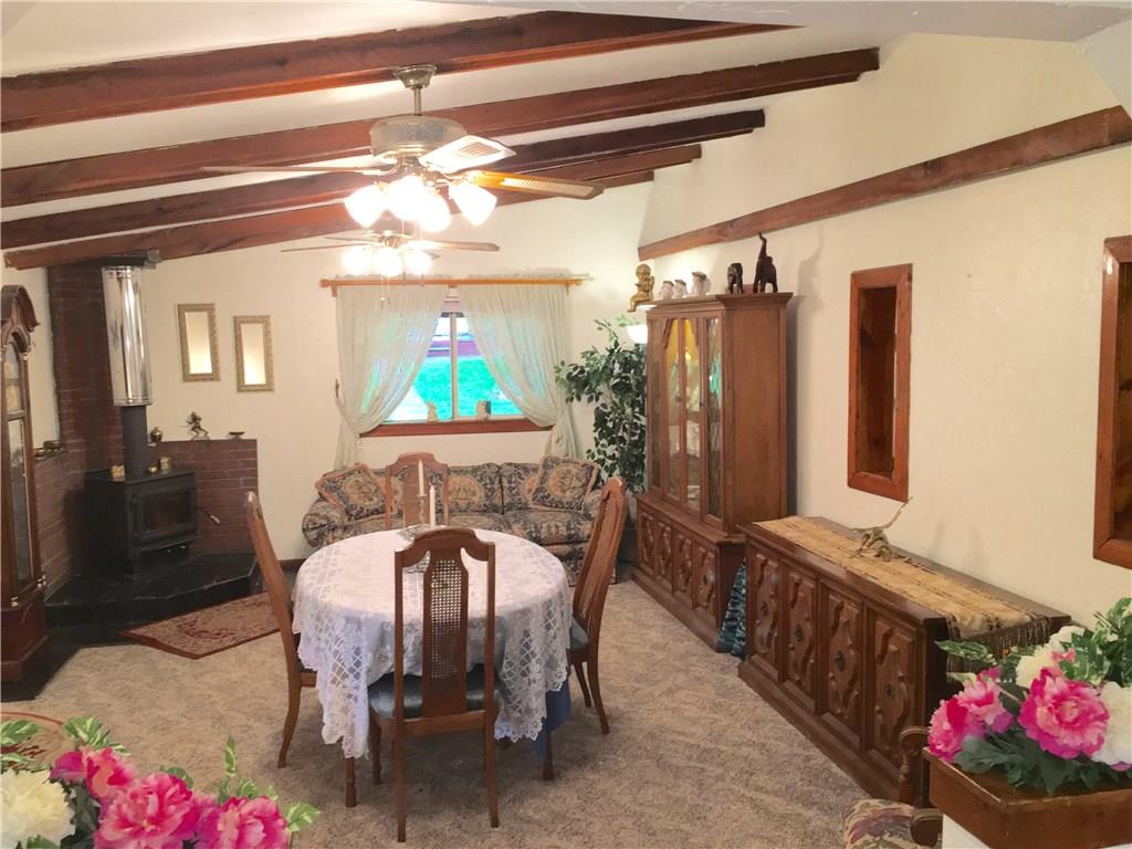 105 Plank Road Acme, PA 15610 - Photo 17 of 25 The Dining Room is amazing with a vaulted ceiling, exposed wood beams, wood-burning stove and a window to the covered porch!