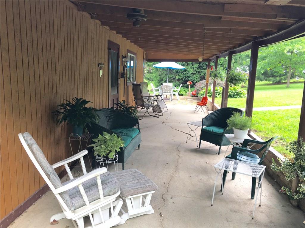 105 Plank Road Acme, PA 15610 - Photo 8 of 25 A better view of the covered porch with a patio off of the Living Room at the far end of the photo. A place to unwind!
