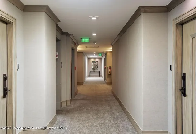 a view of a hallway with wooden shelves