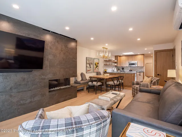 a living room with fireplace furniture and a flat screen tv