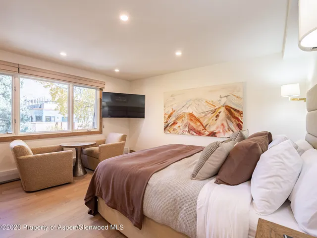 a bedroom with a bed and glass window