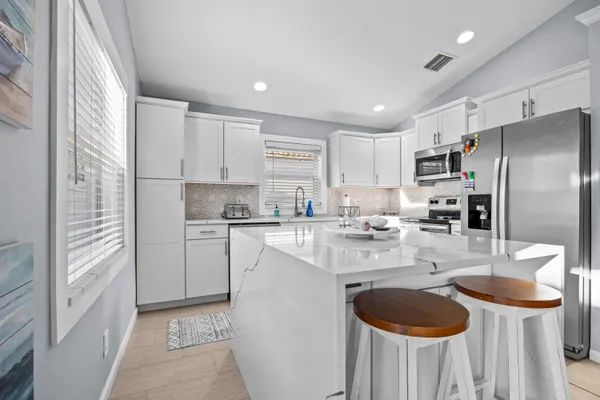 a kitchen with refrigerator and cabinets