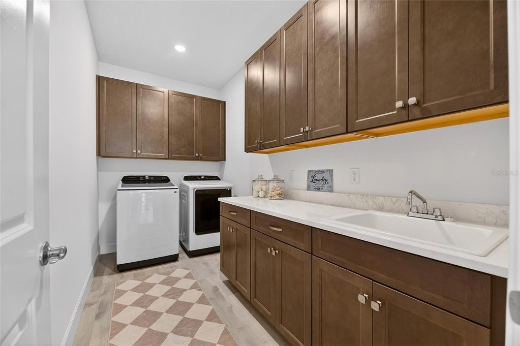 994 Signet Drive Apollo Beach, FL 33572 - Photo 51 of 98 a kitchen with stainless steel appliances granite countertop a sink stove and cabinets
