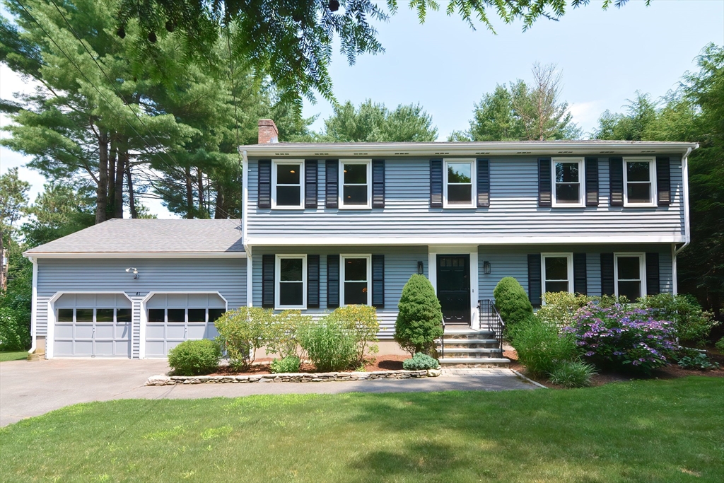 41 Eaton Road Framingham, MA 01701 - Photo 1 of 42 a front view of a house with a yard and potted plants