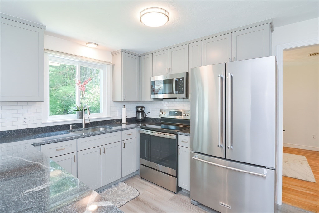 41 Eaton Road Framingham, MA 01701 - Photo 11 of 42 a kitchen with stainless steel appliances a refrigerator sink and microwave