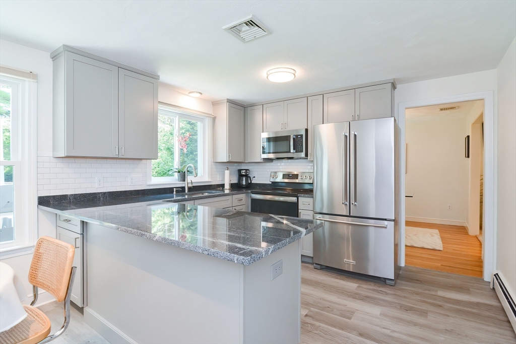 41 Eaton Road Framingham, MA 01701 - Photo 12 of 42 a kitchen with kitchen island a counter top space cabinets and stainless steel appliances
