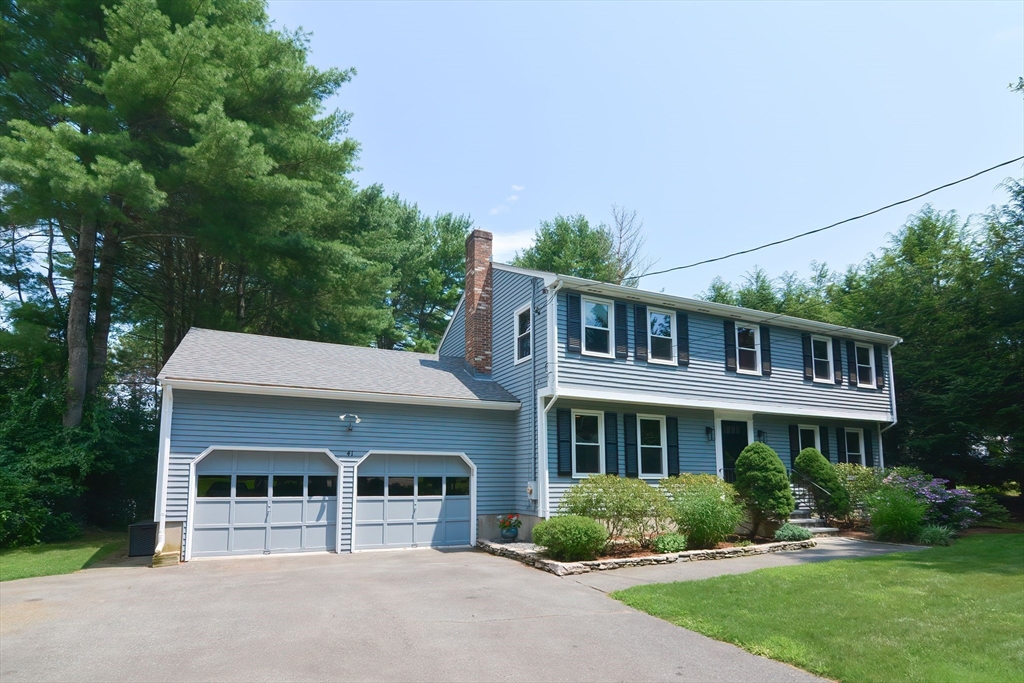 41 Eaton Road Framingham, MA 01701 - Photo 2 of 42 a front view of a house with a yard and potted plants