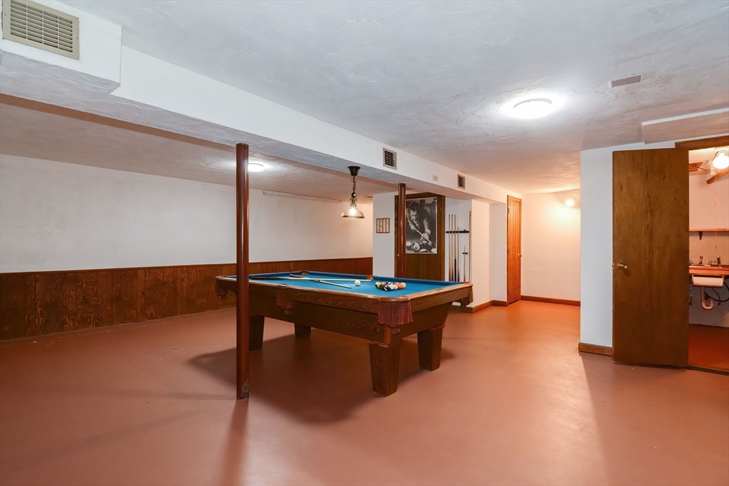 41 Eaton Road Framingham, MA 01701 - Photo 30 of 42 a room with gym equipment and a table