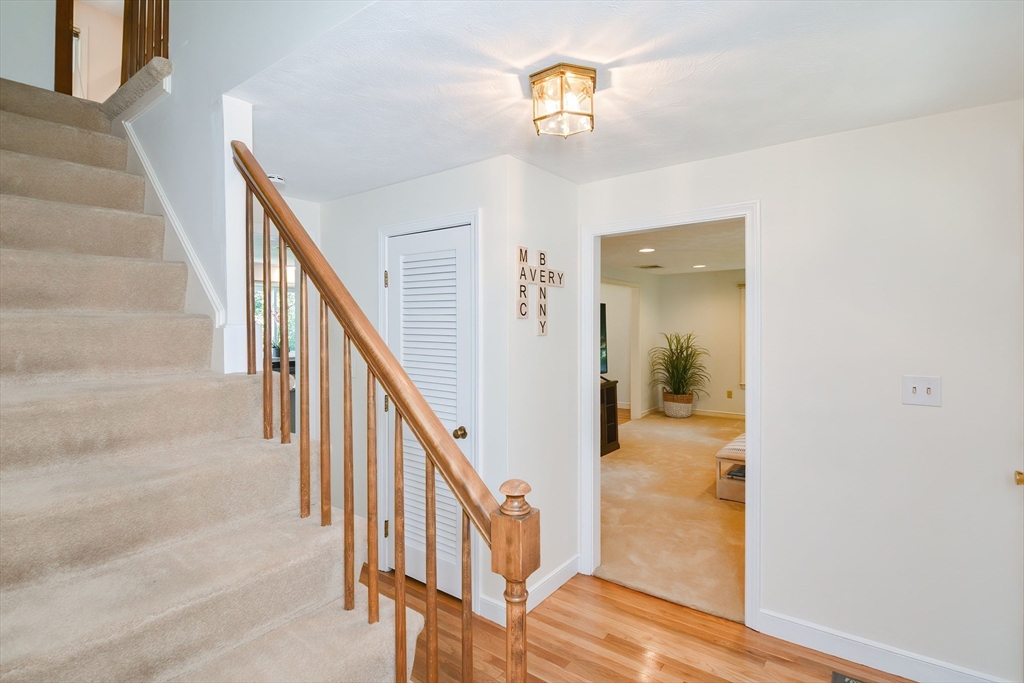 41 Eaton Road Framingham, MA 01701 - Photo 4 of 42 a view of a hallway with wooden floor and staircase