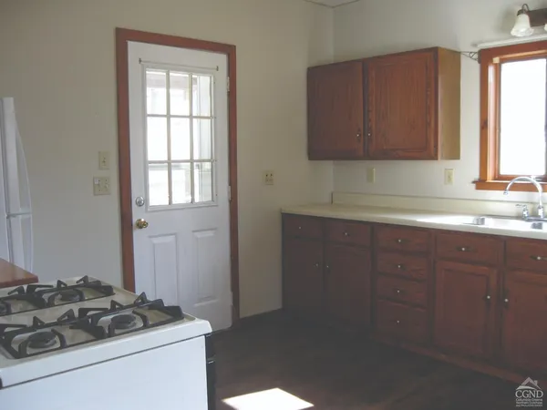 a kitchen with sink a stove and cabinets