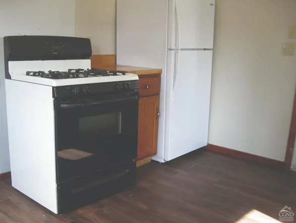 a stove top oven sitting inside of a kitchen