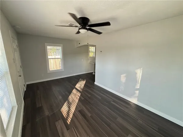 a view of wooden floor and windows in a room
