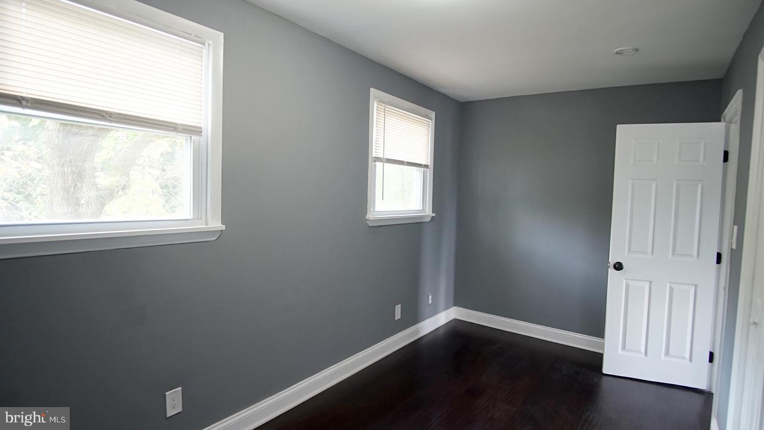 6501 Randolph Road Morningside, MD 20746 - Photo 25 of 35 an empty room with wooden floor and windows