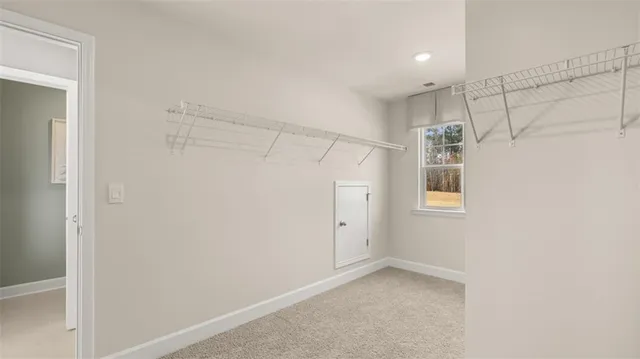 a bedroom with a bed and a potted plant