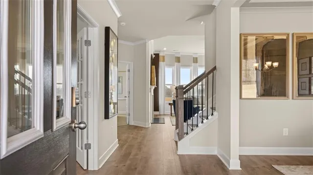 a kitchen with stainless steel appliances a refrigerator and a hard wood floor