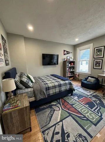 a bedroom with two beds and a couch