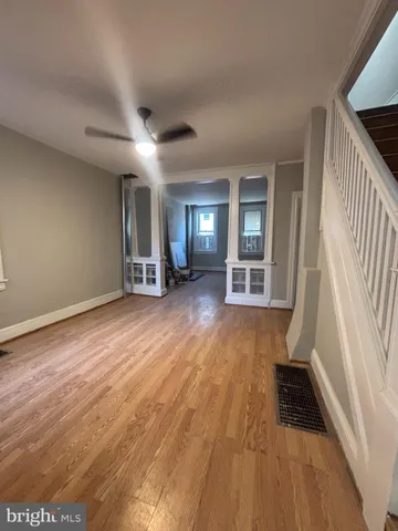 wooden floor in an empty room with a fireplace