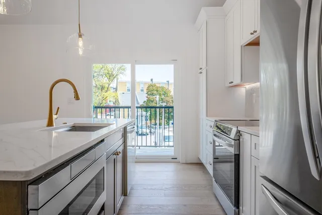 a kitchen with a sink stove and refrigerator