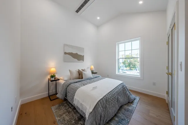 a bedroom with a bed and a night stand