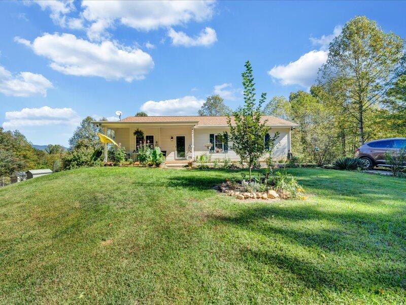 860 Holland Road Callaway, VA 24067 - Photo 2 of 30 a front view of a house with garden and trees