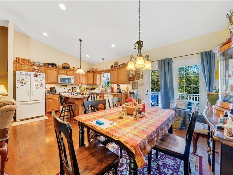860 Holland Road Callaway, VA 24067 - Photo 12 of 30 a view of a dining room and livingroom with furniture wooden floor a rug a painting and a chandelier