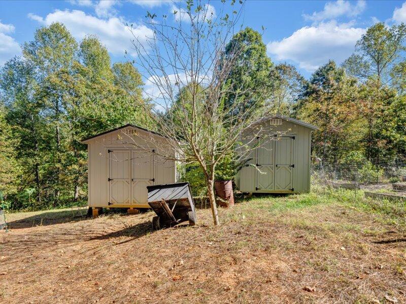 860 Holland Road Callaway, VA 24067 - Photo 29 of 30 a backyard of a house with a yard and garage